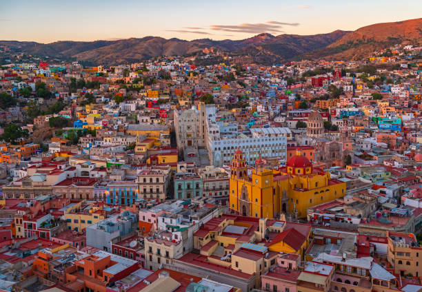 The colorful cityscape of Guanajuato at sunset with the landmark of the Basilica of our Lady of Guanajuato, Guanajuato state, Mexico.